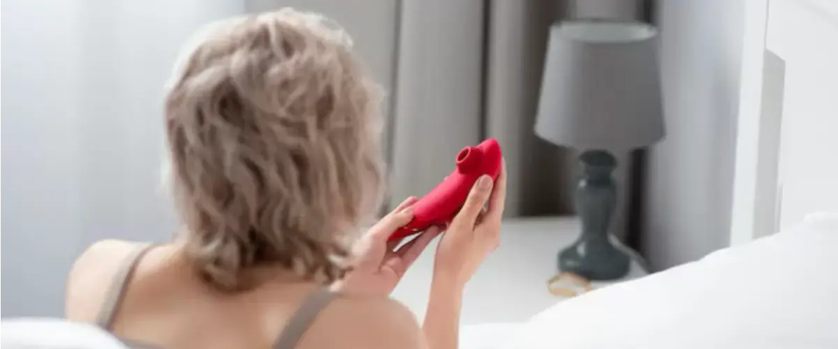 woman using clitoral suction vibrator