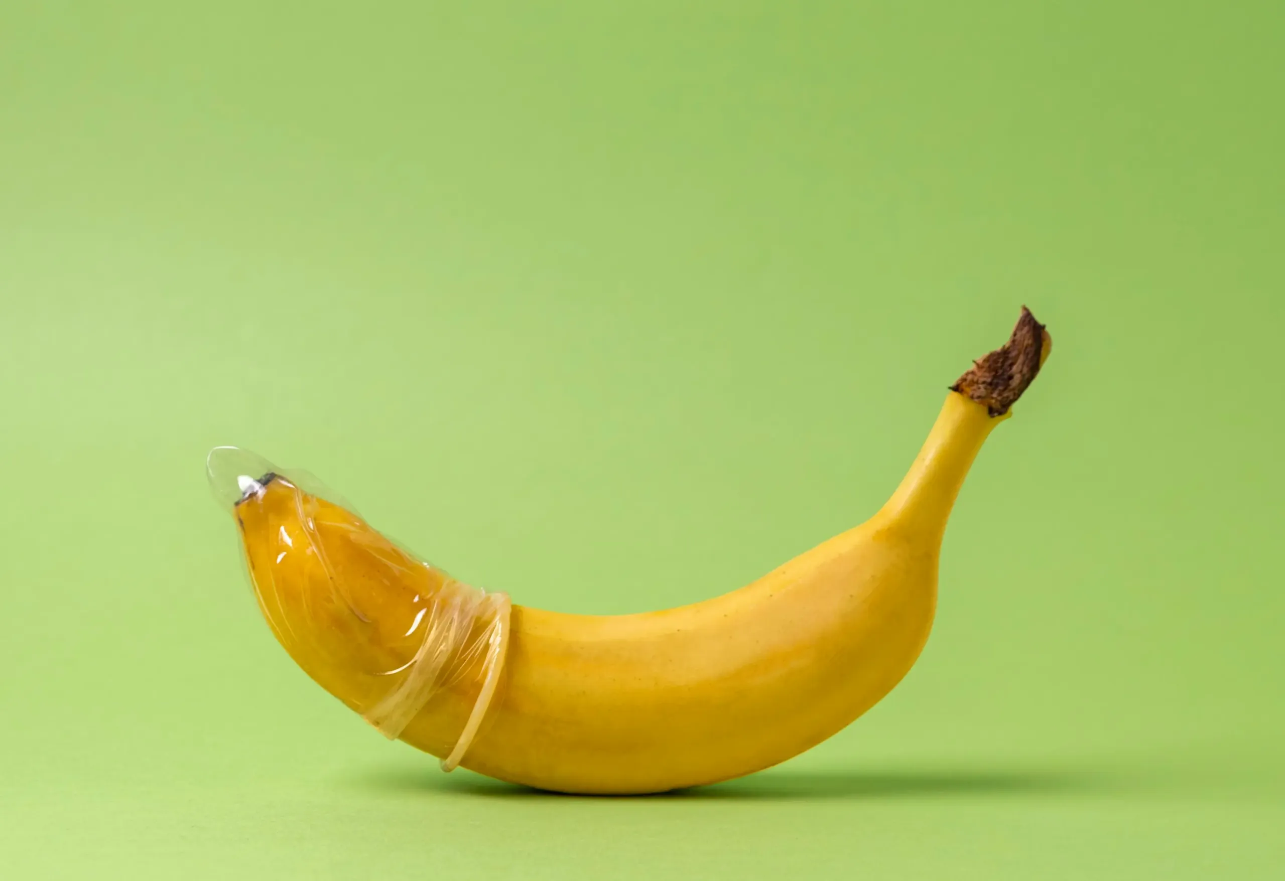 Fruits as sex toys concept with woman in kitchen and discreet adult toy packaging, illustrating intimate safety concerns